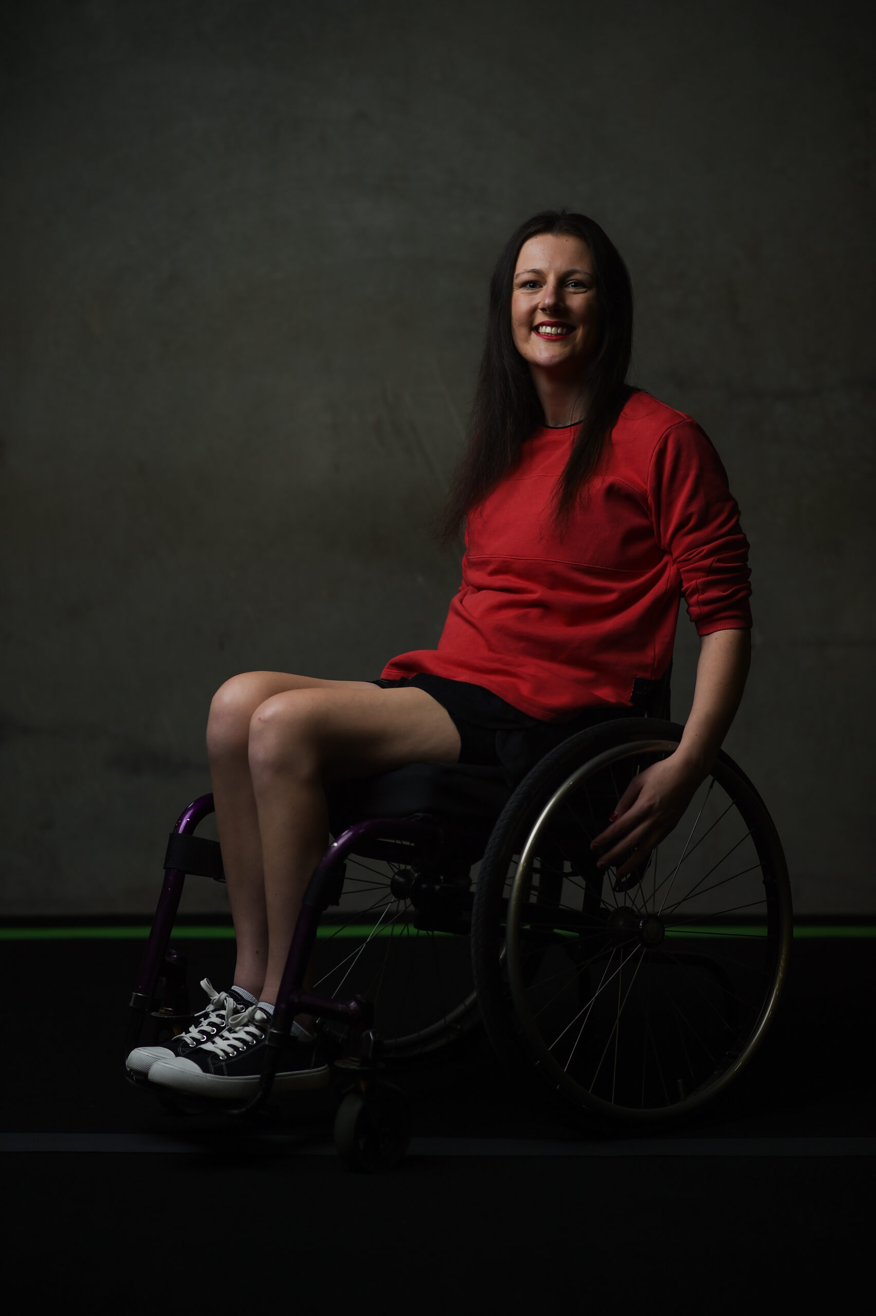 Woman in a wheelchair in a red tshirt