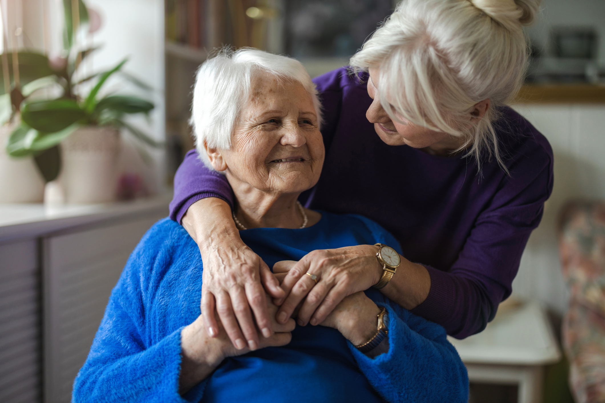 Woman hugging her elderly mother image